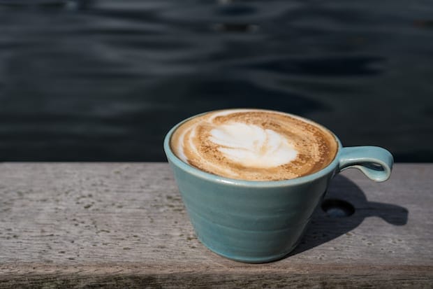 coffee on a ledge that looks like a cappuccino or a latte