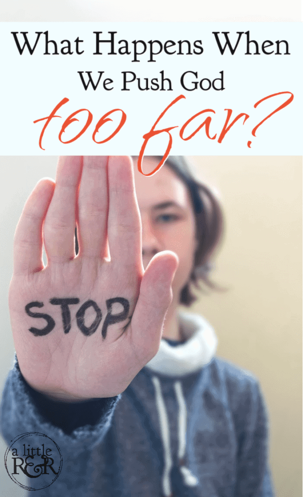 person holding up hand with the word stop written on palm