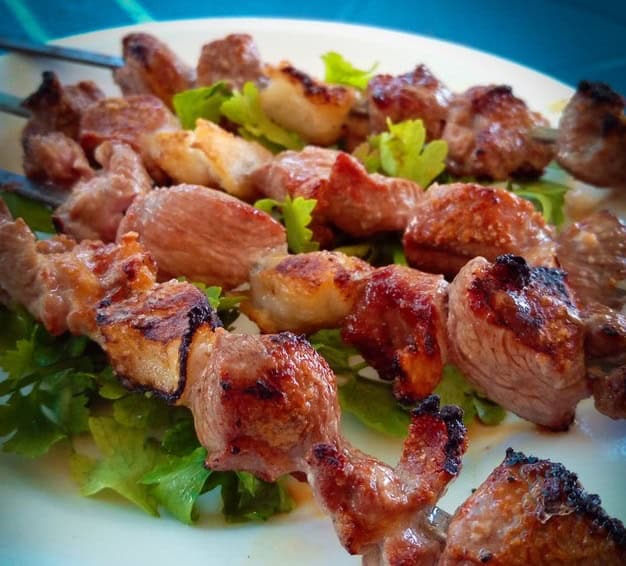 Chicken breast skewers grilled on the BBQ and served on a bed of lettuce leaves