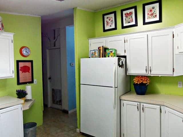 kitchen with green walls and white cabinets