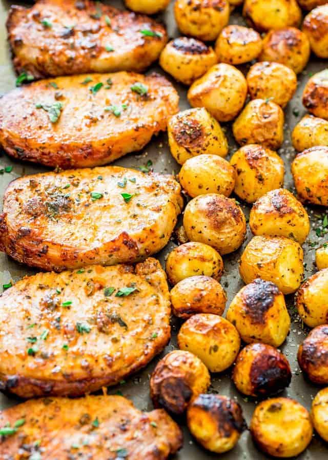 pork chops and small potatoes roasted in sheet pan