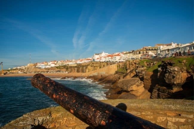 The village up on the cliffs and the main beach below. Walking along Ericeira cliffs is one of the best things to do in Ericeira.