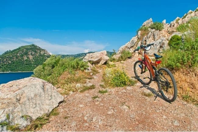 Electric bike on a cliff. Renting an electric bike to ride to different beaches is one of the best things to do in Ericeira