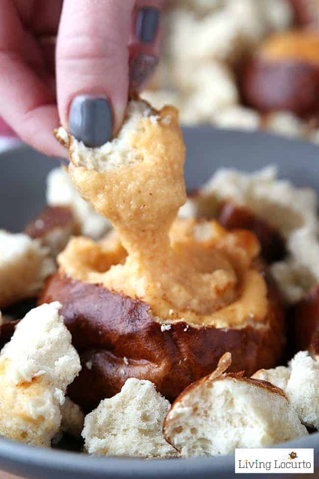 Hot Beer Cheese Dip in pretzel bread bowls. A crowd pleasing appetizer recipe for any party! With a little spicy kick, these Hot Beer Cheese Dip Pretzel Bread Bowls are perfect snacks for game day, a birthday party or happy hour with friends. Serve the cheese dip in a crock pot slow cooker along side of vegetables, pretzels or any other kind of bread. A mini pretzel bread bowl is a perfect way to eat Beer Cheese Dip because you don’t have to worry about double dipping! LivingLocurto.com