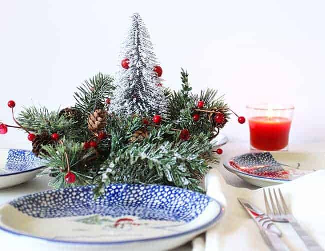 Festive Christmas centerpieces arrangement with candles, ornaments, and greenery