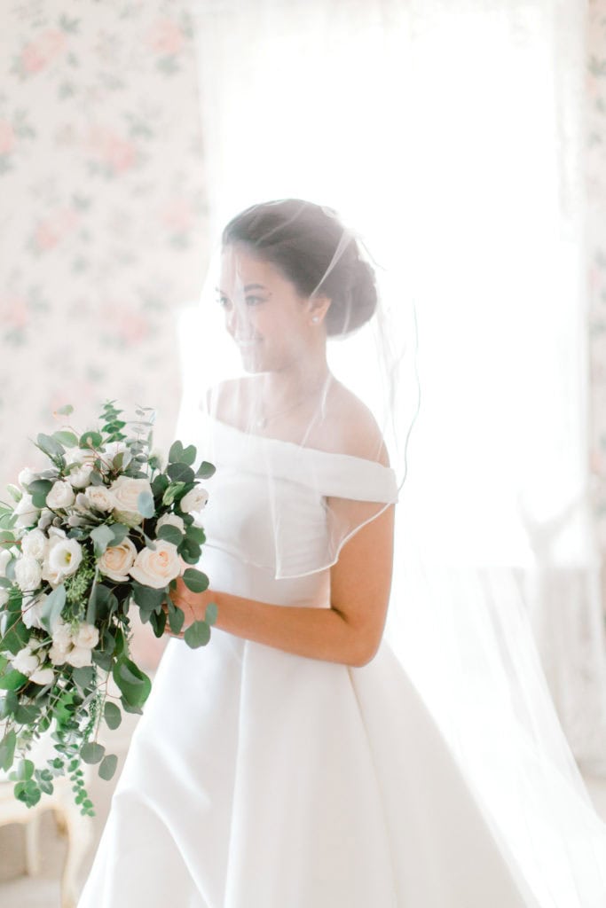 bride holding flowers looking away from the camera