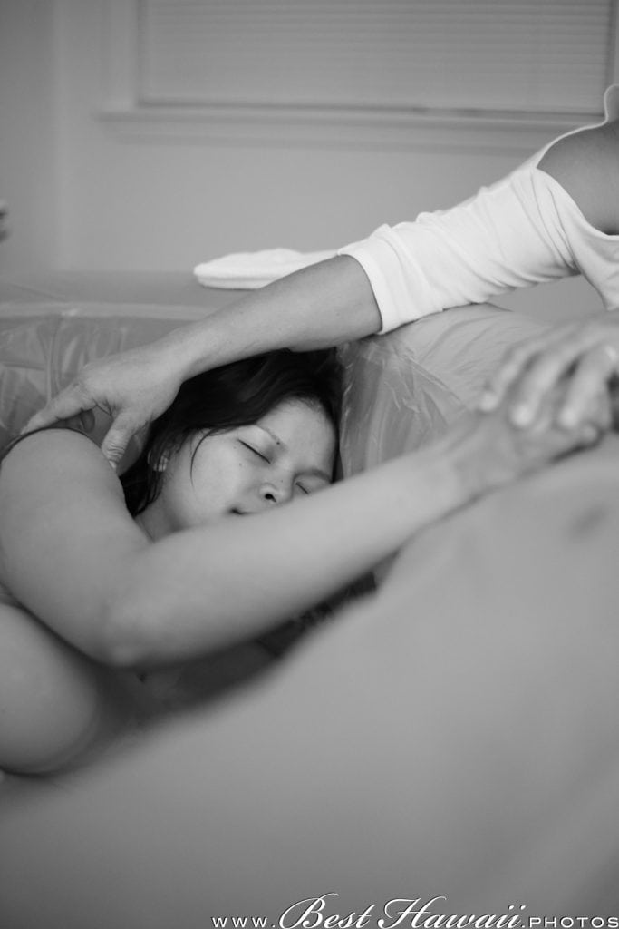 Mother holding mother-to-be during a home water birth