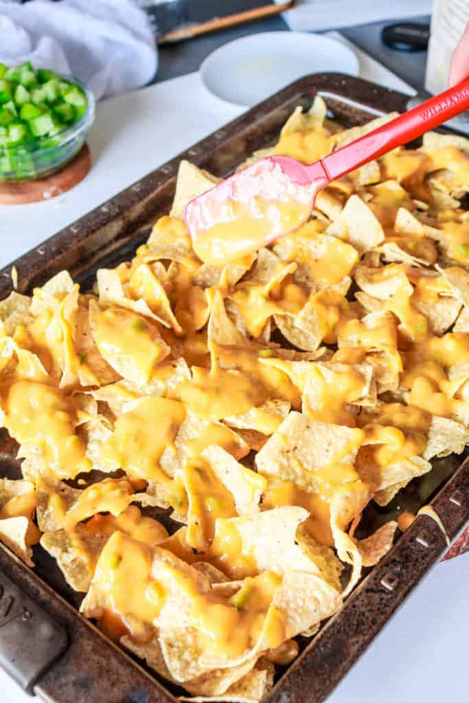 Vegan loaded nachos recipe with tomatillos and vegan queso cheese sauce. It’s easy to make and makes a perfect appetizer or a meal! #nutfree #nachos #veganrecipe