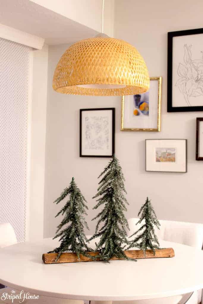 Faux evergreen trees on kitchen table.  Classic simple Christmas decorations in my home.