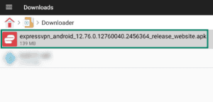 File Manager + app interface on Android TV, showing the Downloader folder and a highlighted ExpressVPN APK file.