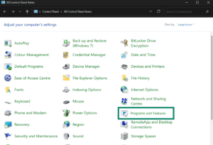 Windows Control Panel showing all items in large icon view, with the "Programs and Features" option highlighted inside a teal box.