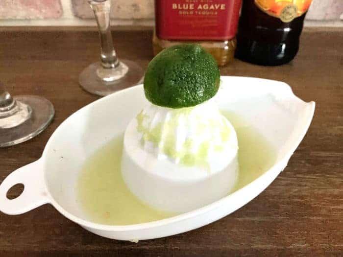 Lime being juiced on a juicer