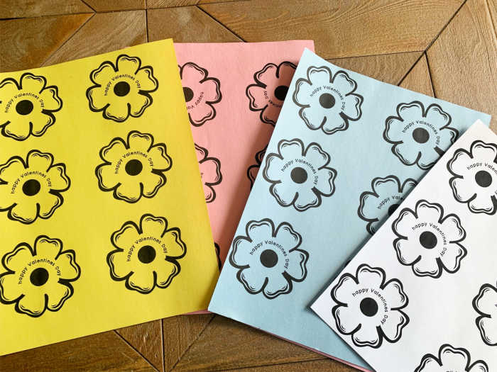 Flower images on colored construction paper ready to be cut out.