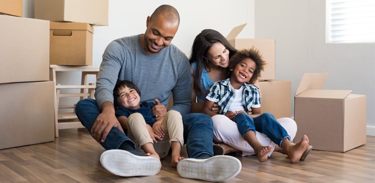 Happy family moving into a home