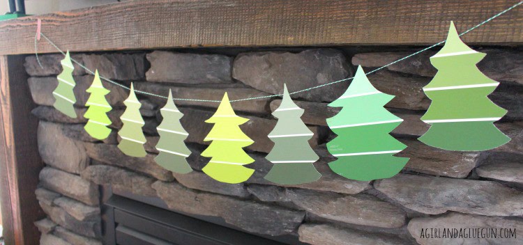 trees cut out of paint chips hanging from mantle