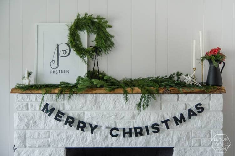 merry christmas banner hanging from fireplace