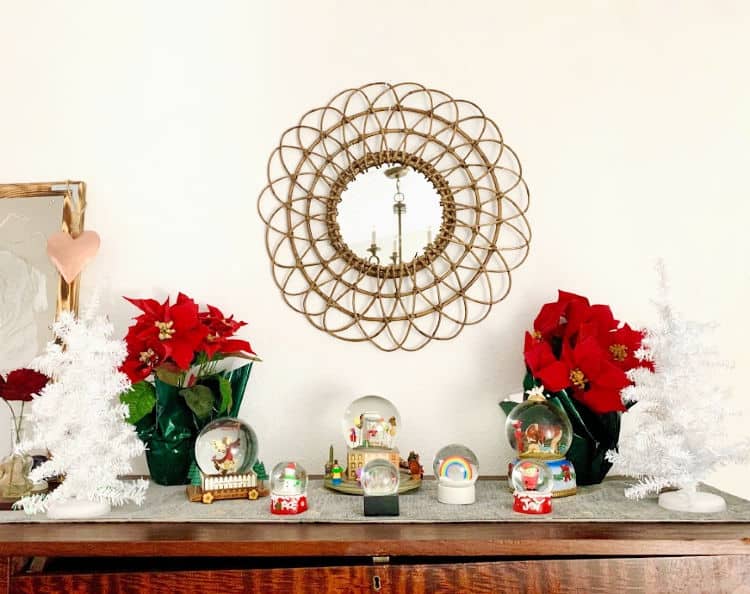 snow globes on a wooden dresser make lovely Christmas bedroom decor.