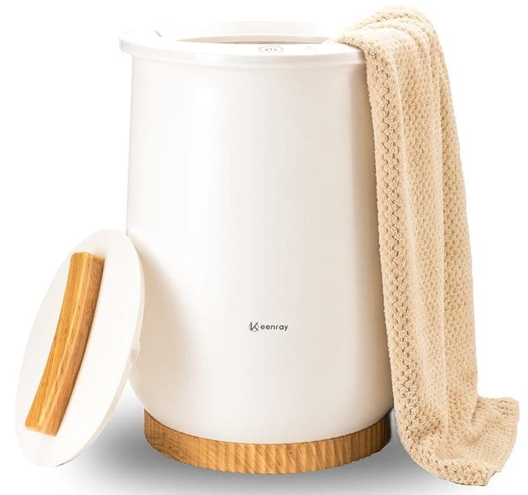 Image shows the towel warmer, there is a pink towel hanging from the right hand side.