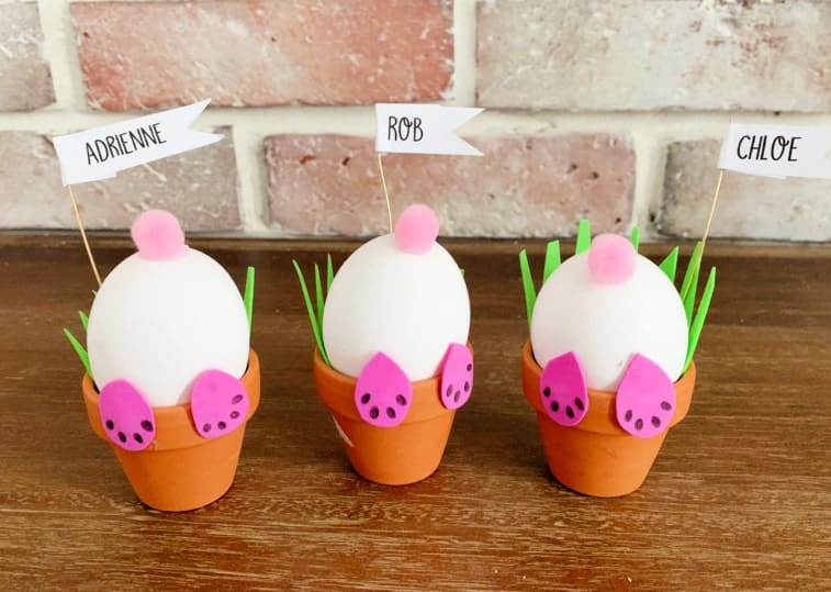 3 bunny pots with name tags in front of brick wall