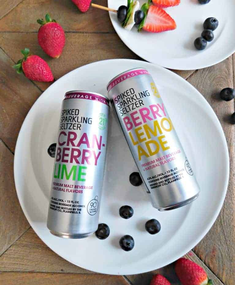 two cans of spiked sparkling seltzer on a white plate.