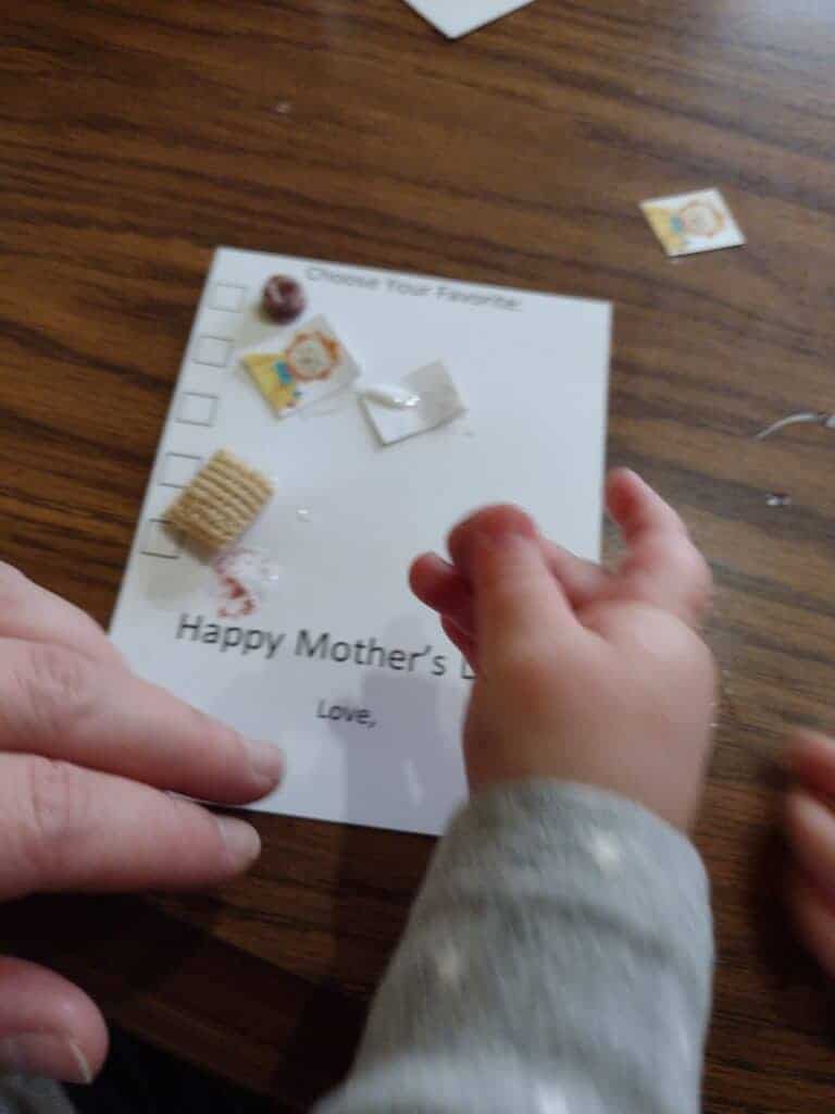 Picture of a one year old tearing a gluey melt off a checklist