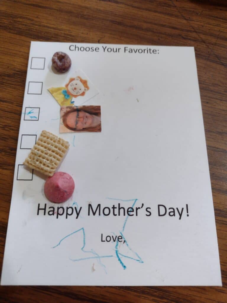 Picture of a checklist mother's day craft with object glued on it by a one year old