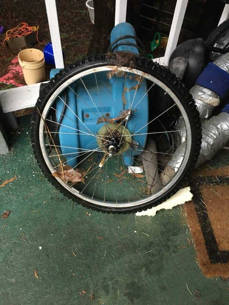 old bike wheel on front porch