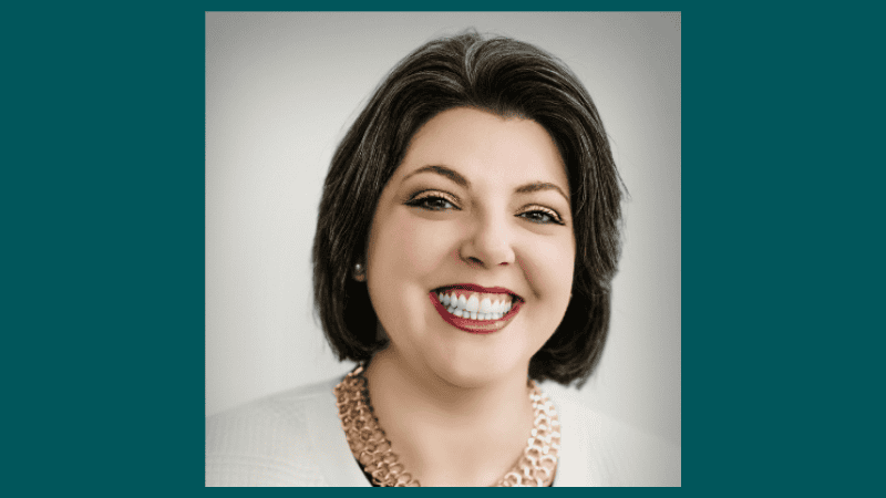 A woman with short dark hair smiles
