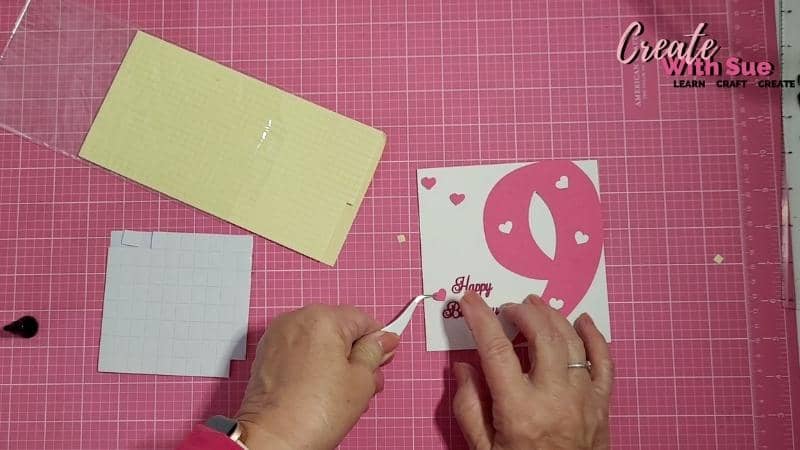 Adding the heart with foam tape to add some depth to the 9th birthday card