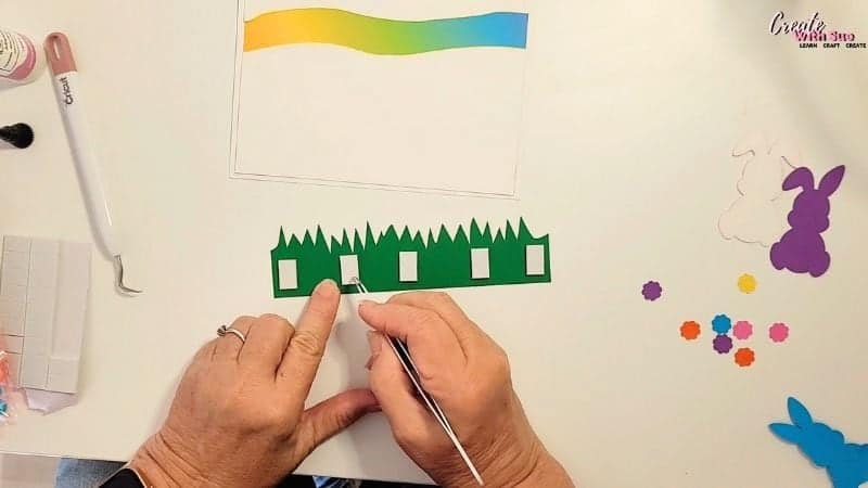 Adding the foam tape to the green grass section of the Easter Bunny card