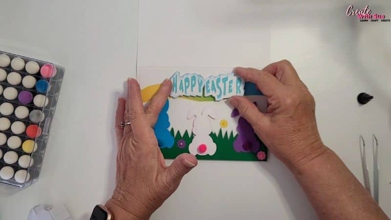 Placing the text onto the card using foam tape for additional dimension