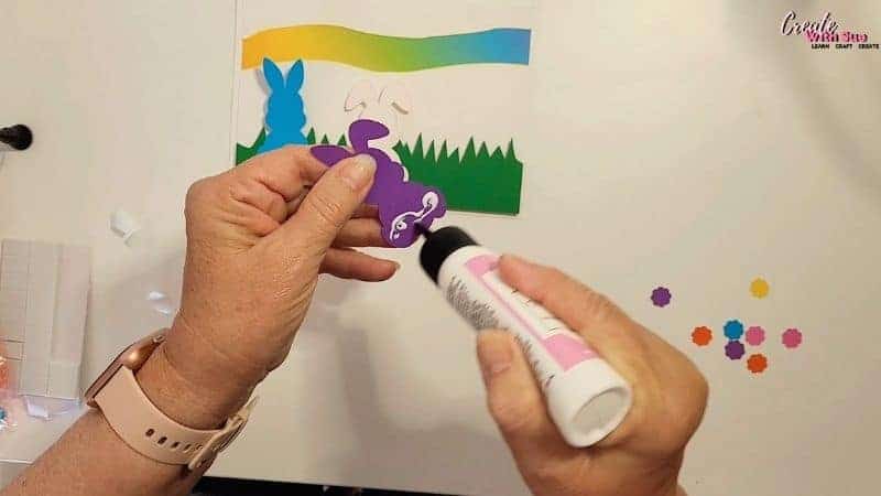 Glueing the bunny to go on the green grass section of the Easter Bunny Card
