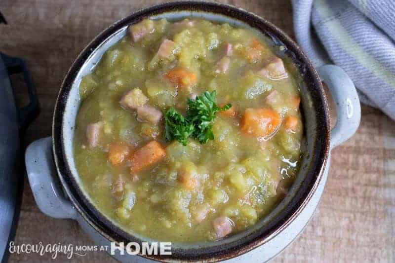 Split Pea and Ham Soup in a rustic Bowl on the counter.