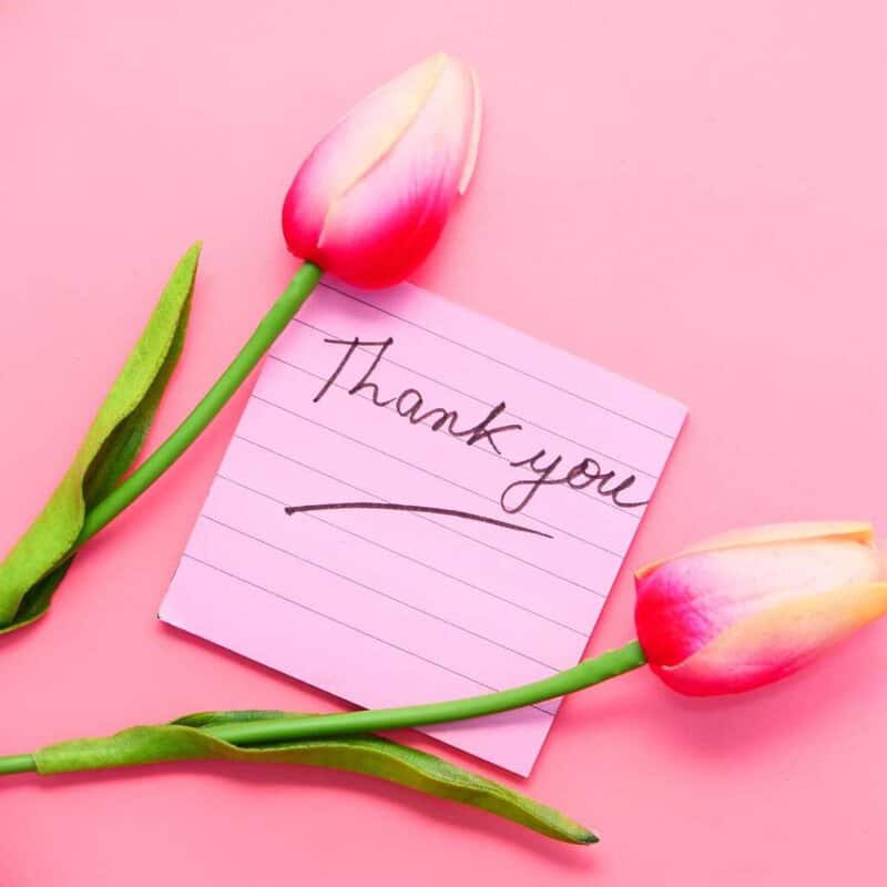 thank you quote with beautiful pink flowers on table