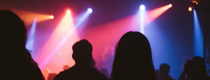 People silhouetted by disco lights