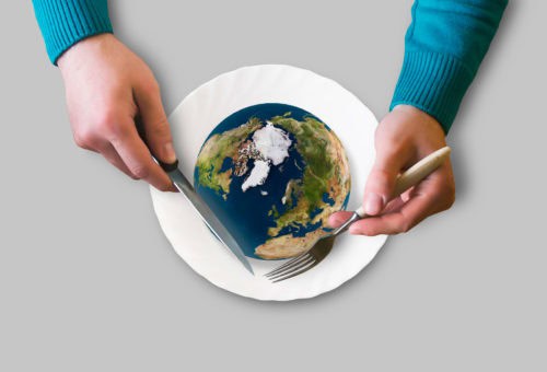 earth on a plate, hands holding knife and fork