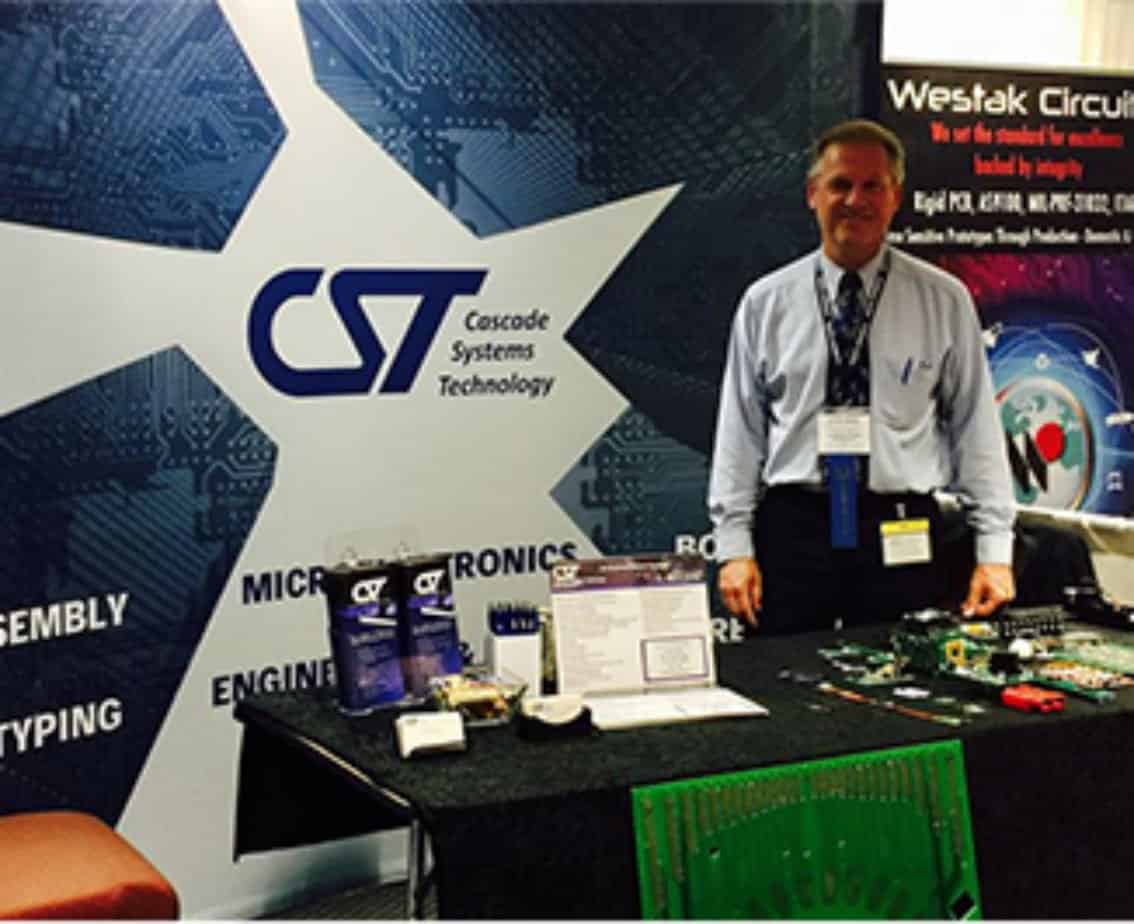 CST electronic contract manufacturing services rep at a trade show