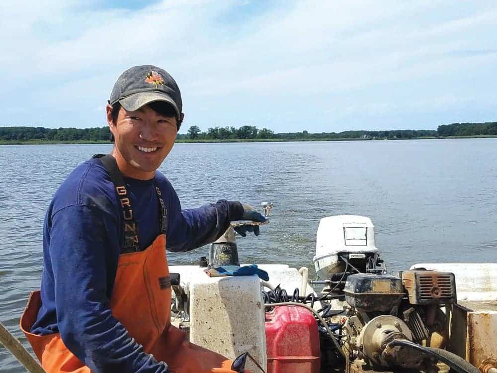 Scott Budden and mate Sean Corcoran on the Chester River, working Budden’s oyster lease. Photo by Laura Boycourt.