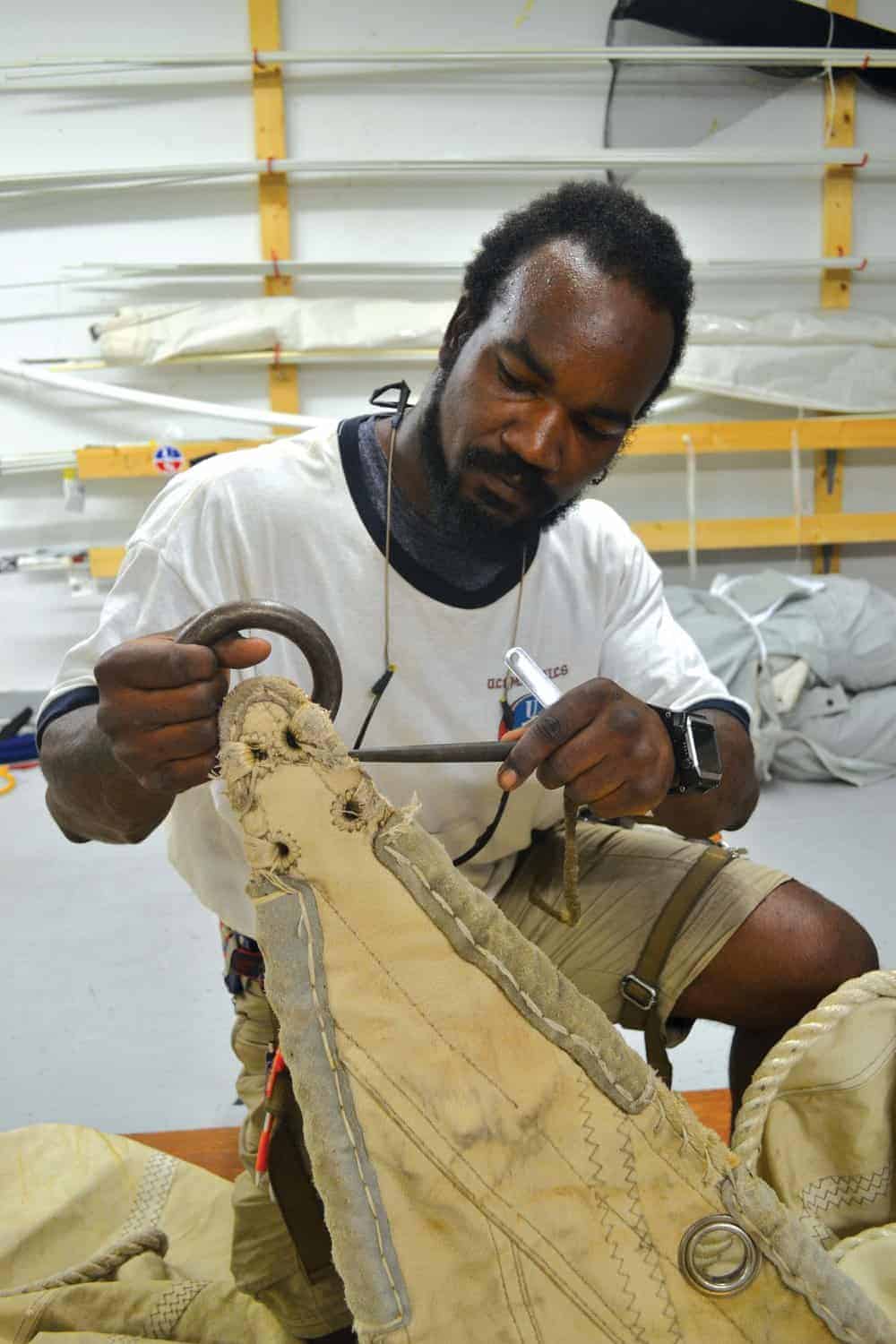 Dantes Chambre-Serres examines one of the Eagle ’s old sails. Photo by Karen Soule.