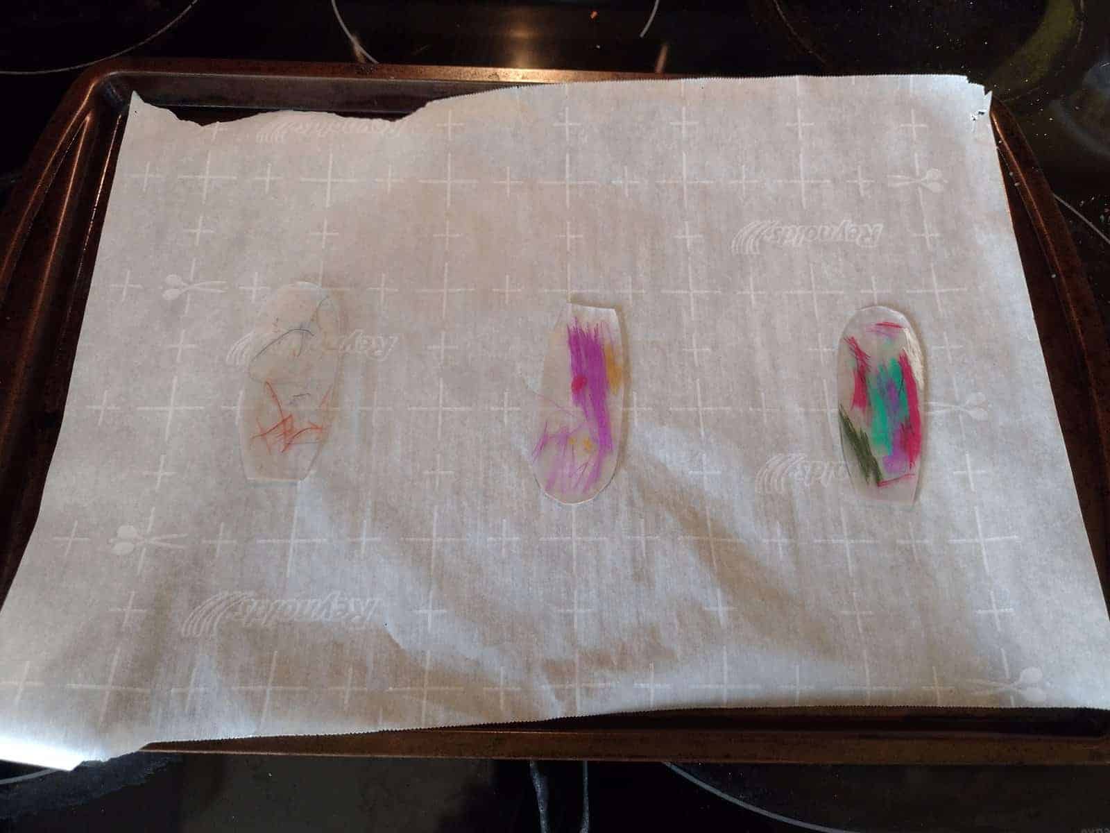Picture of three flower petal shaped Shrinky Dinks for a pinwheel after shrinking