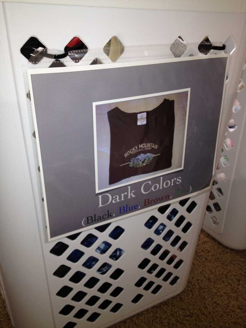 Tall Laundry Basket with a sign reading "Dark Colors: Black, Blue, Brown and Green." and a picture of a brown t-shirt.