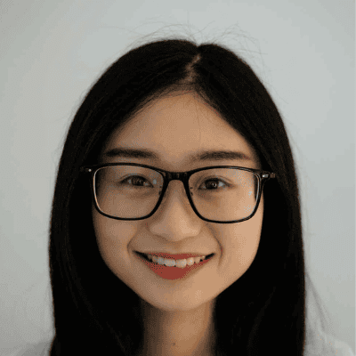 A woman with long dark hair and glasses