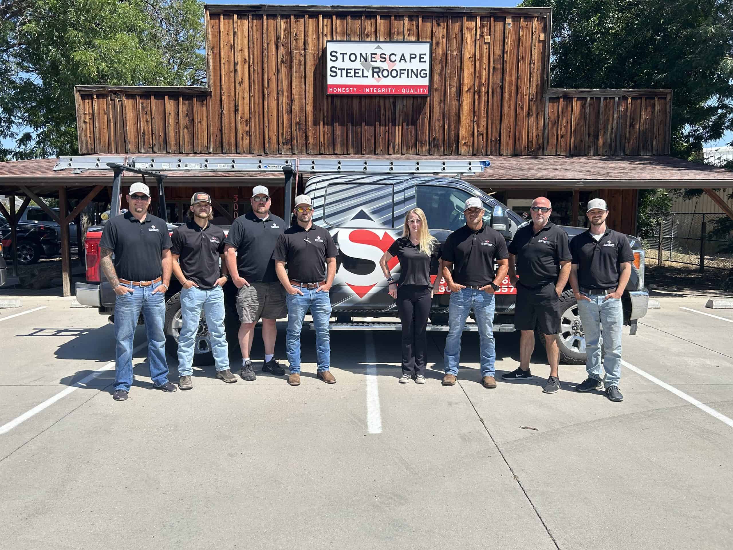 Stonescape employees standing in front of wrapped company truck and building