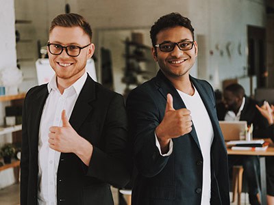 Two men in suits giving thumbs up for quality business phone service providers