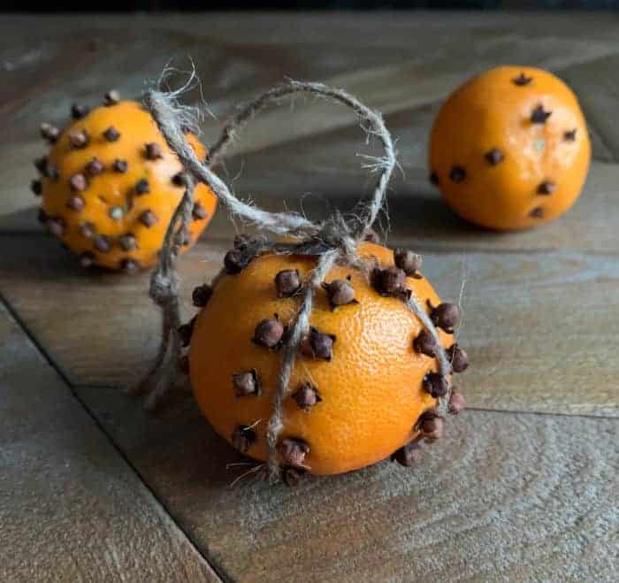 orange pomanders on a wood table