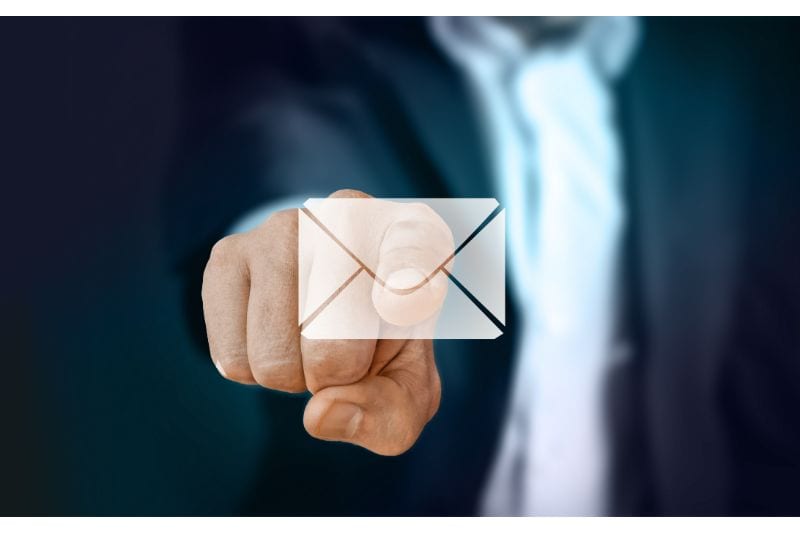Hand clicking on an email envelope icon, relevant to email authentication (PTR - Policy Record)