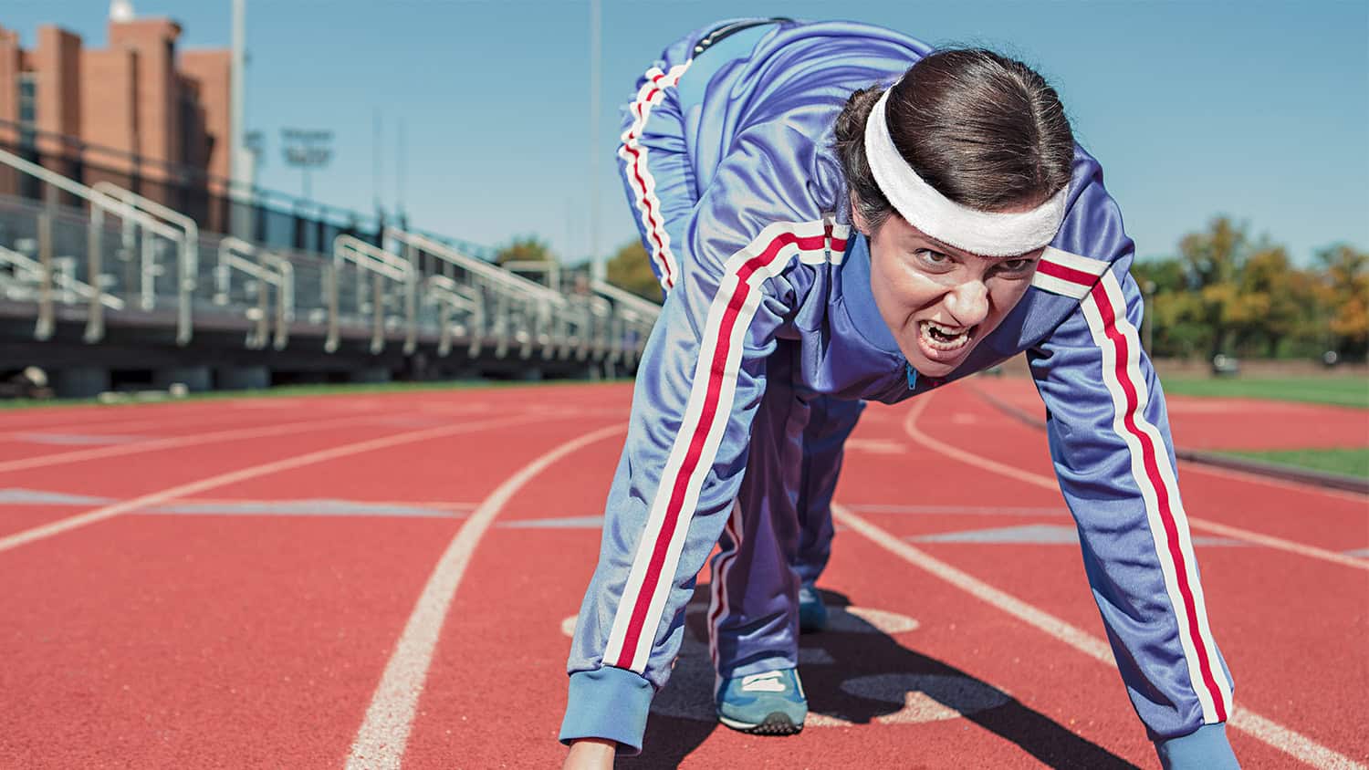 Woman on running track looking determined