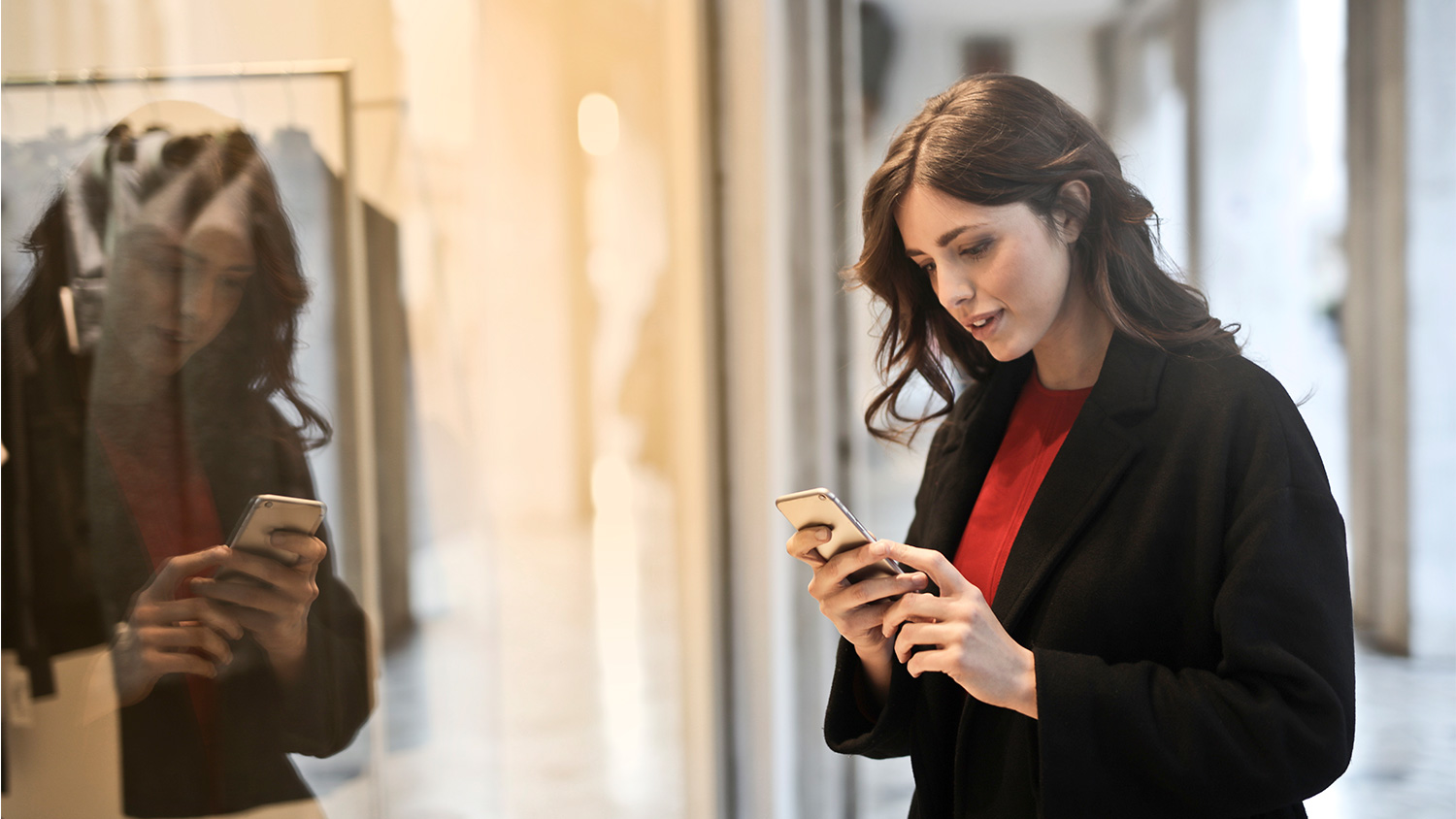 woman looking at phone in retail setting