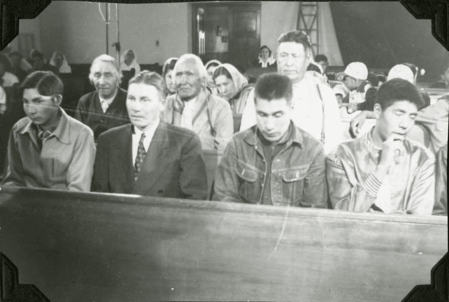 Community members in chapel during filming of a movie. 1952. Shingwauk Residential Schools Centre, Algoma University.