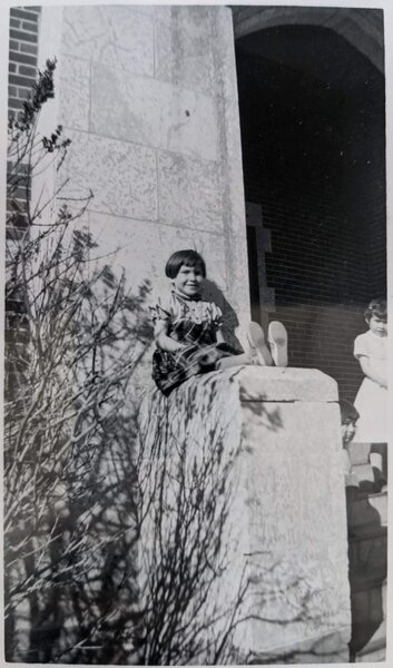 Girl poses on front entrance of Blue Quills, April 1959. PR2010.0475 from The Provincial Archives of Alberta, Open Copyright.